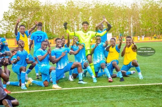 Joueurs en tenue de football bleue et jaune posant ensemble en célébration sur un terrain de football vert